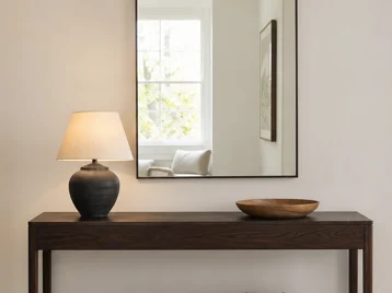 Large arched mirror correctly proportioned above a modest walnut console