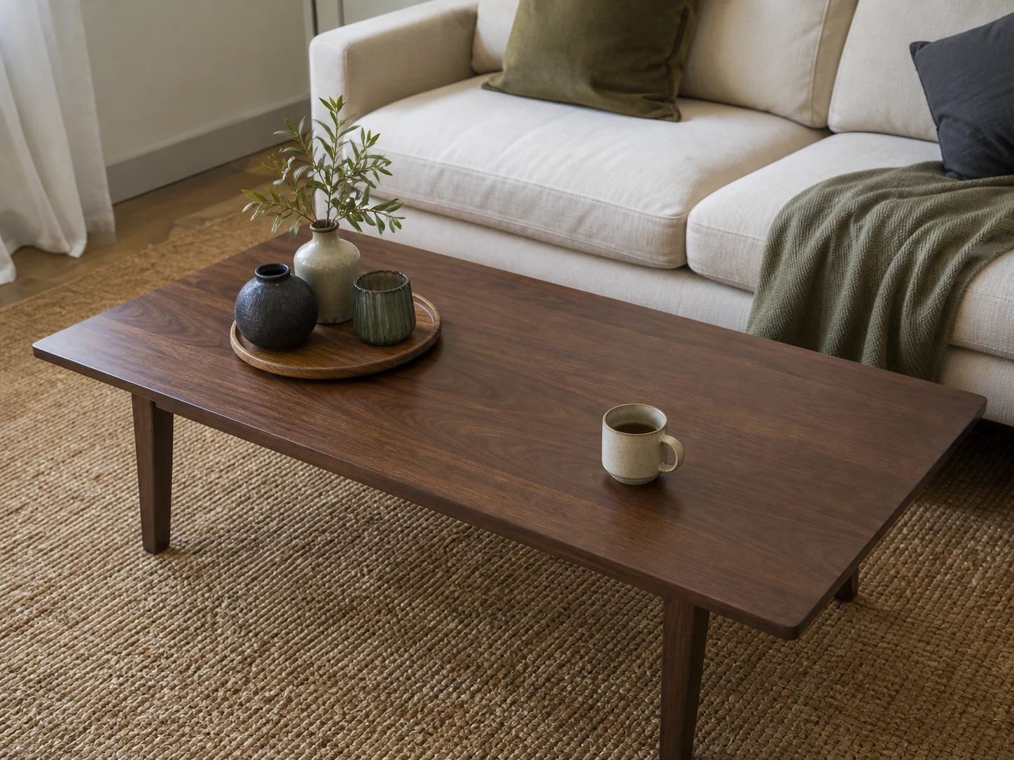 Compact decor tray on one side of a coffee table with a large clear landing area and mug