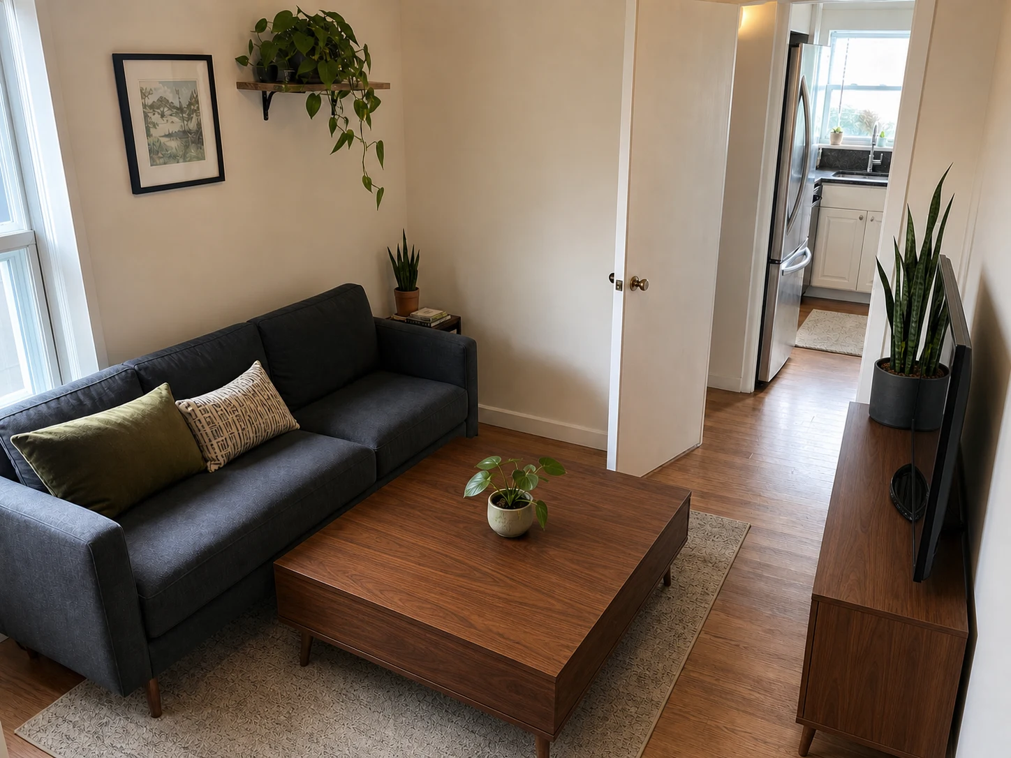 Small living room with oversized coffee table close to sofa and narrowed route to kitchen